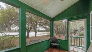A covered porch with a view of a lake and trees. - Lakefront Country Haven near Ocala & Forest -With Canoe, Lifejackets and Grill! (Ft McCoy)