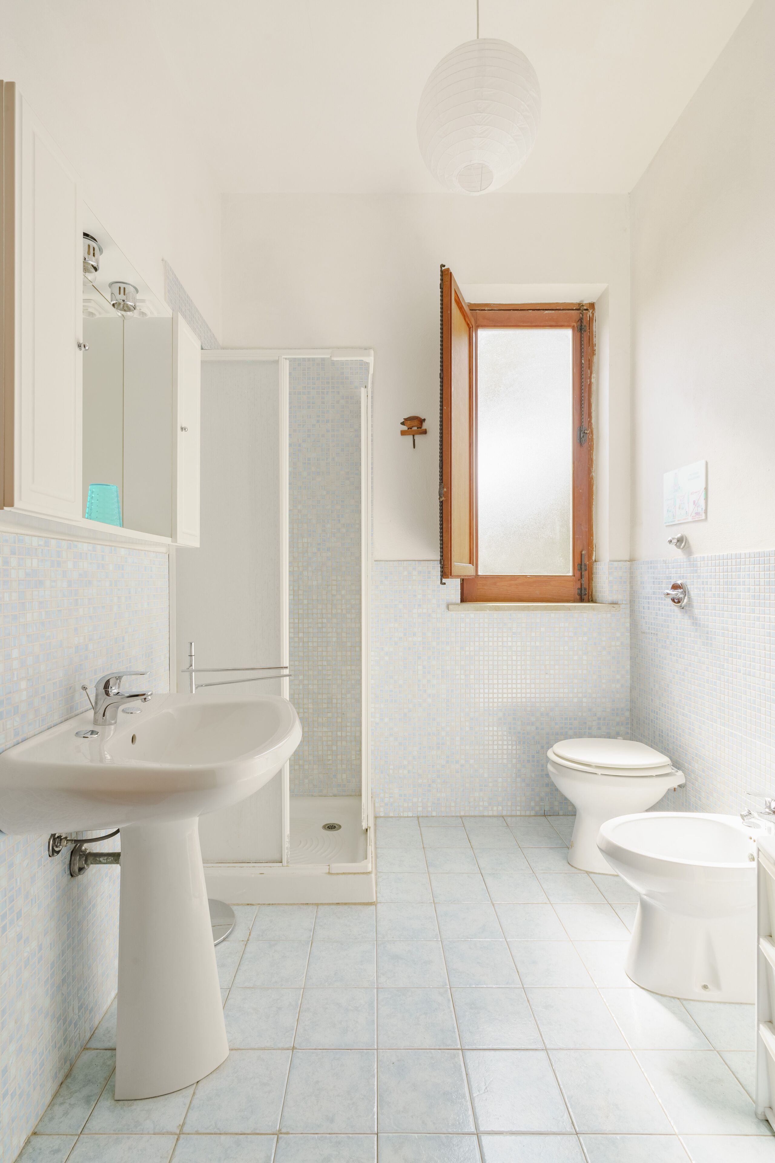 A bathroom with a sink, toilet, and shower.