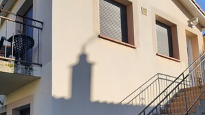 A two-story building with a staircase and a balcony.