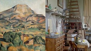 Una habitación con un cuadro de un paisaje, muebles de madera y una escalera.