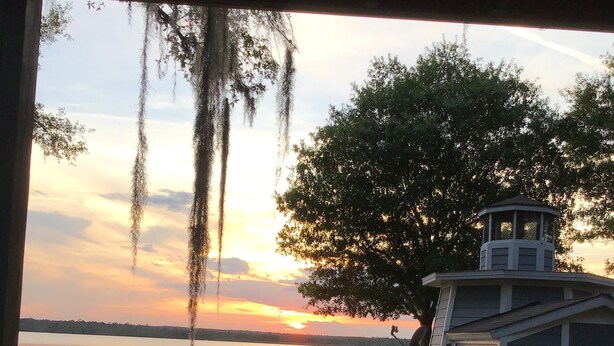 A lakeside view with a gazebo, a small shed, and a picnic table. - Three Bedroom House on Private Lake Delancy in Ocala National Forest (Salt Springs)