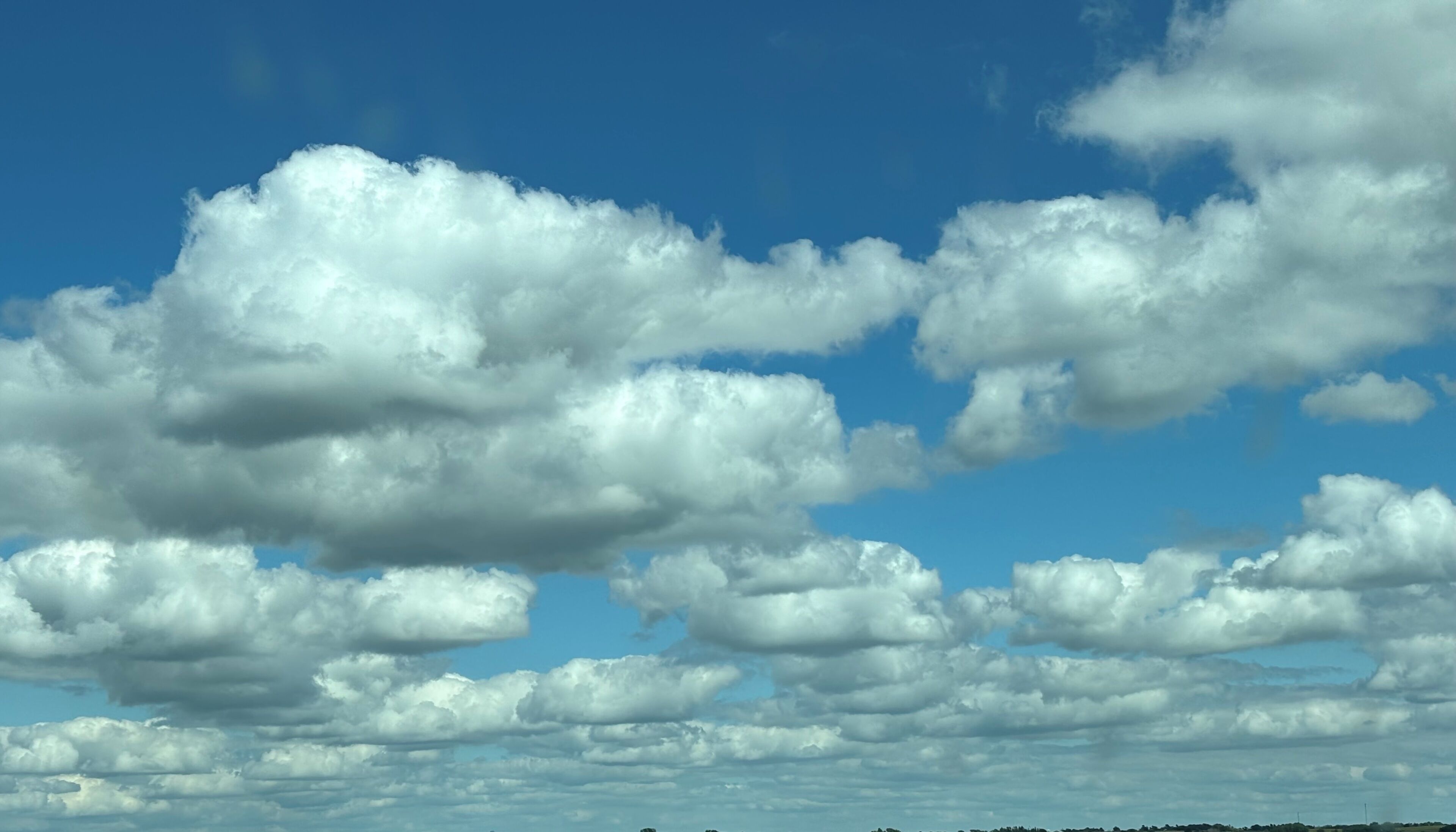 A clear sky with scattered clouds.