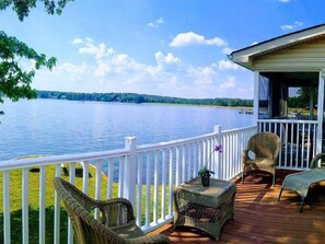 A deck with wicker furniture and a view of a lake. - Wyndham Fairfield Plantation (Villa Rica)