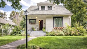 A single-story house with a front porch, a small garden with potted plants, and a visible mailbox. - Walla Walla Gem - Peaceful, Private and a Perfect Central Location  (Walla Walla)
