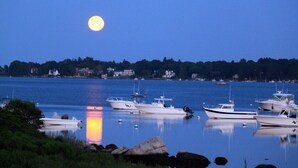 A calm harbor at dusk with boats docked and a full moon in the sky. - Stunning Sunsets on Quonnie Waterfront- 2 Kayaks, Beach Pass & Backyard Clamming (Charlestown)