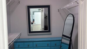 A room with a blue dresser, a mirror, and two white shelves. - 1 Bedroom Studio located near Isle of Palms and downtown Charleston! (Mt Pleasant)