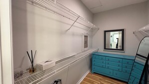 A bathroom with a white vanity, a mirror, and a blue dresser. - 1 Bedroom Studio located near Isle of Palms and downtown Charleston! (Mt Pleasant)