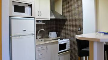 Apartment, 2 Bedrooms | Private kitchen | Fridge, microwave, stovetop, coffee/tea maker