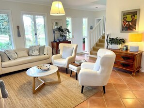 A living room with a sofa, armchairs, a coffee table, and a staircase leading to another level. - MILLHAVEN - beautiful home in superb location with ocean views. (Quedjinup)