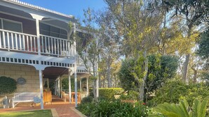 A two-story building with a covered porch and a brick pathway leading to the entrance. - MILLHAVEN - beautiful home in superb location with ocean views. (Quedjinup)