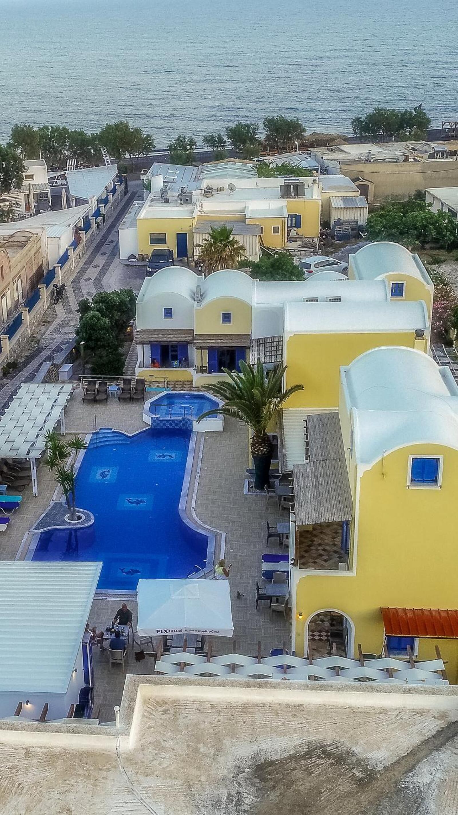 A resort with multiple swimming pools, a beach view, and a variety of building styles.