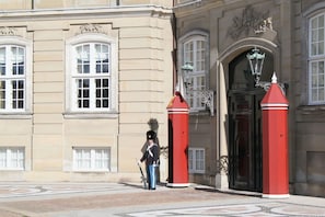 A building with classical architecture, featuring a large arched entrance and a uniform facade.