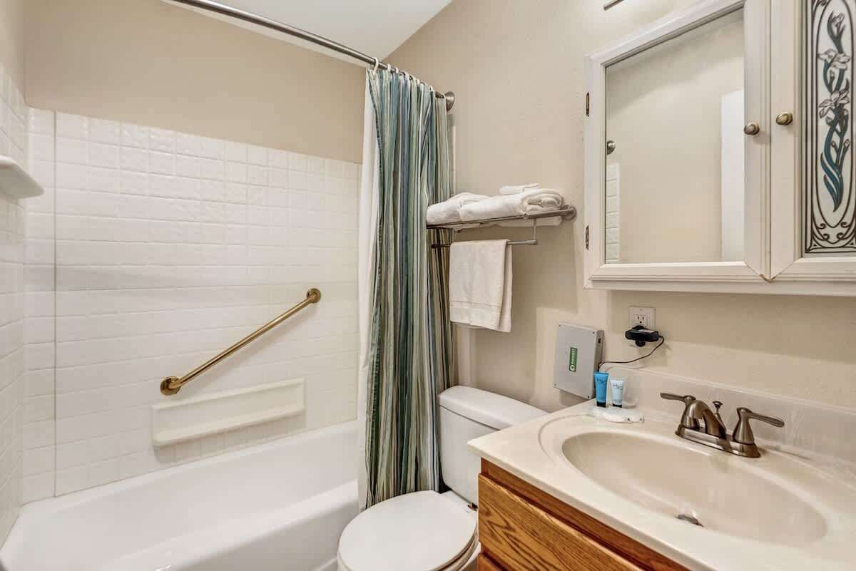 A bathroom with a bathtub, toilet, and sink.