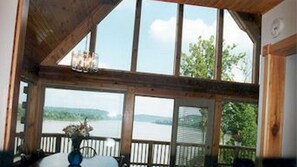 Enjoy breathtaking views of the water and surrounding landscape from this room's expansive window.