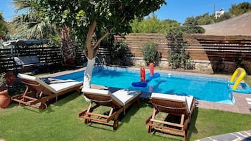 A heated pool, sun loungers