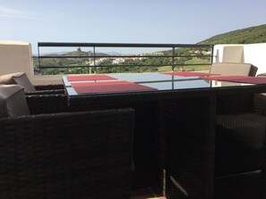 Relax on the terrace with a glass-top table and comfortable seating.