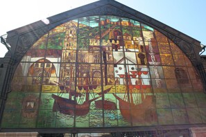 A stained glass window with intricate designs and maritime themes. - Cozy apartment with beautiful view on golf course, mountains and nature reserve. (Alhaurin El Grande)