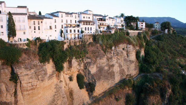 A coastal town with buildings built on a cliffside, overlooking a rugged coastline. - Cozy apartment with beautiful view on golf course, mountains and nature reserve. (Alhaurin El Grande)