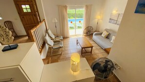 A living room with a sofa, chairs, a table, and a fan. - Villa Cristina, air conditioning, private pool, free WiFi (Binibeca)