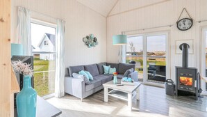 A cozy living room with a sofa, coffee table, and a fireplace. - Awesome home in OstseeResort Olpenitz with sauna (OstseeResort Olpenitz)