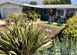 Stroll through the beautifully maintained garden, surrounded by lush plants and vibrant flowers.