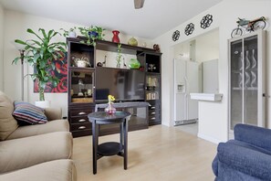 Een woonkamer met een bank, een salontafel en een boekenkast.