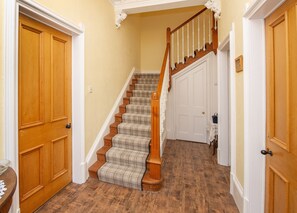 Hallway with door to small downstairs bathroom