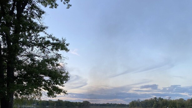 A campfire in a grassy area with a lake and trees in the background. - YEAR-ROUND Private, Cozy Lakeside Cabin. Beautiful Views, 2 Boats, Kayak & Canoe (Ironton)