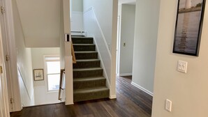 A staircase with carpeted steps leading to a second floor.