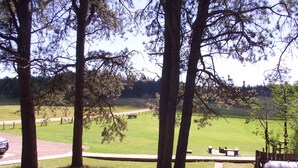 A park with picnic tables, a walking path, and a grassy field. - Pine Crest- Historic 3 bedroom Log Cabin built in the 1930's by the CCC.   (Custer)