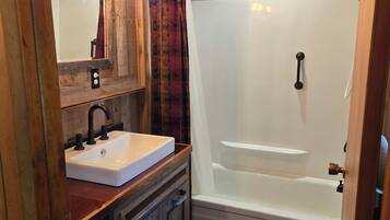Combined shower/tub, hair dryer, soap, toilet paper