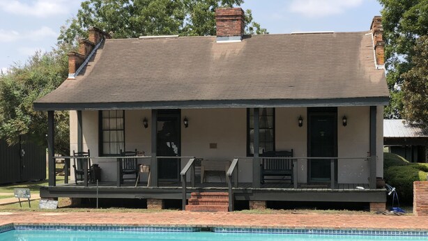 A two-story house with a covered porch, a swimming pool, and a brick exterior. - Loyd Hall Plantation (Cheneyville)