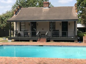 A two-story house with a covered porch, a swimming pool, and a brick exterior. - Loyd Hall Plantation (Cheneyville)