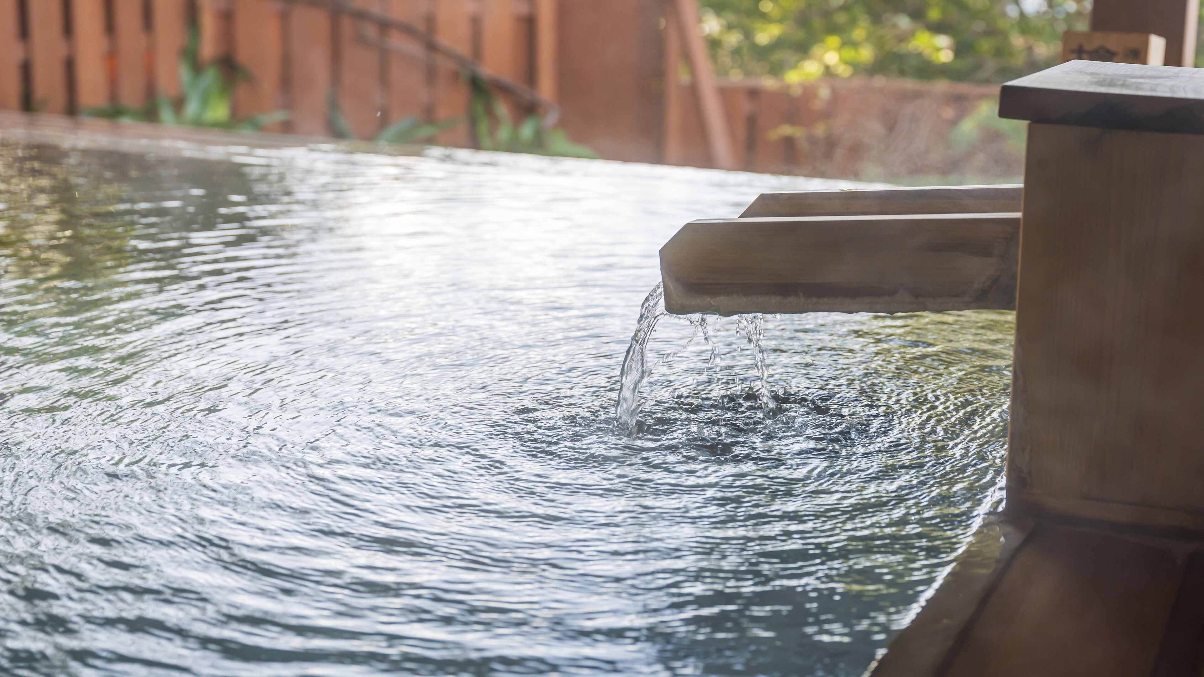 A water feature with a wooden structure and flowing water.