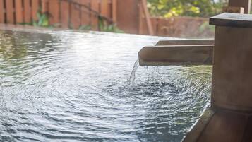 A water feature with a wooden structure and flowing water.