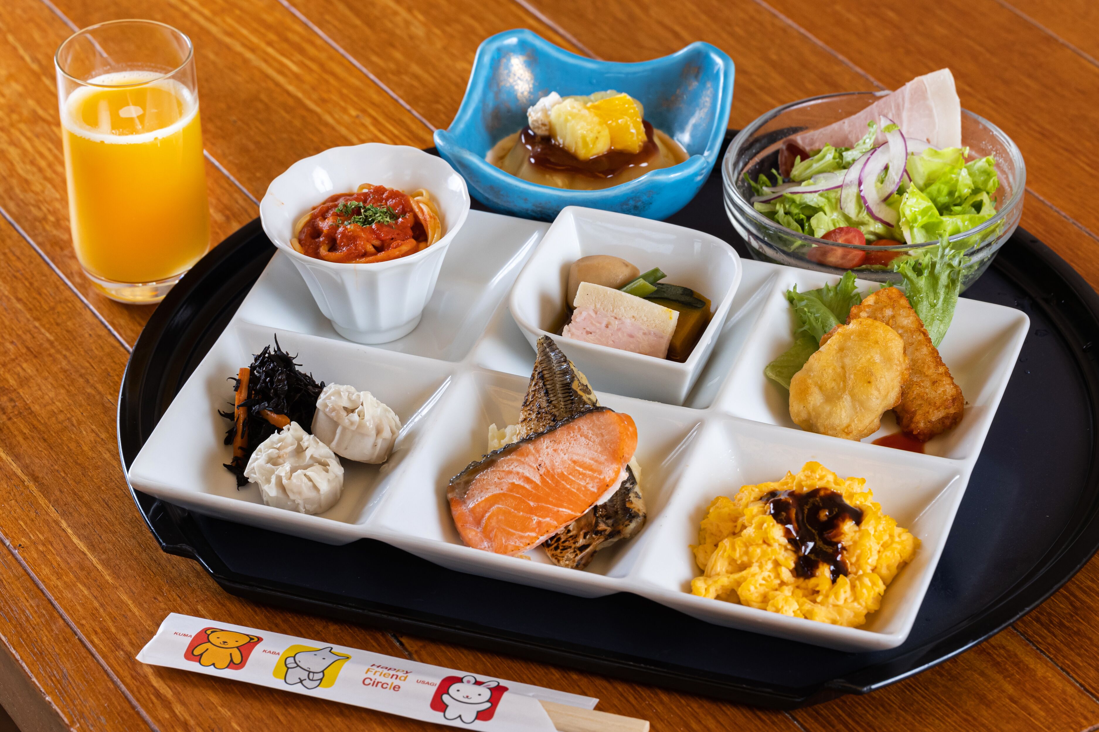 A tray with various food items including salmon, eggs, and a salad.