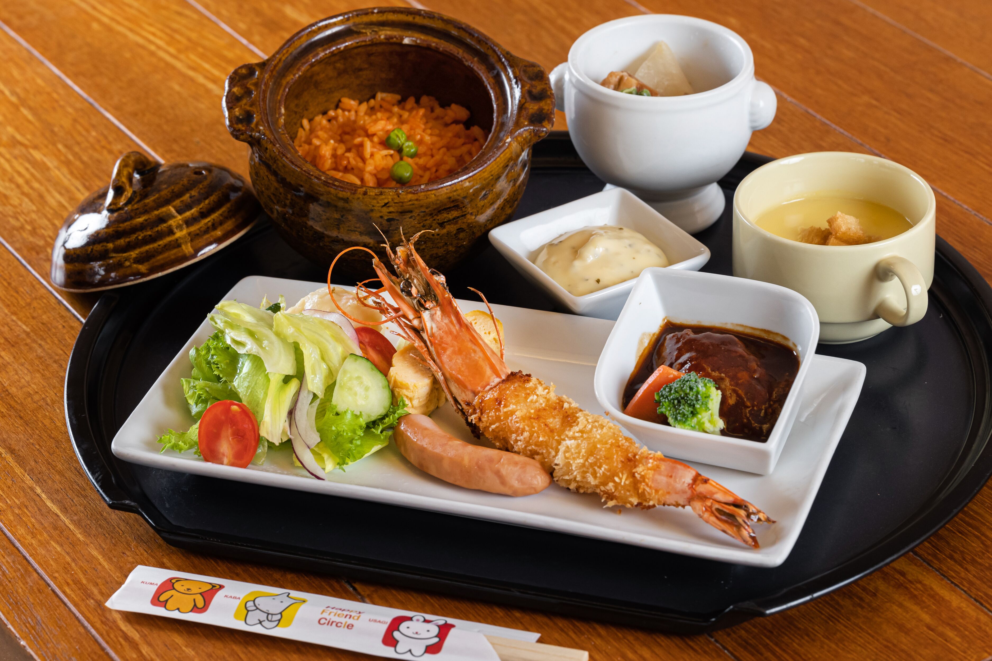 A tray with a variety of dishes including shrimp, salad, rice, and soup.
