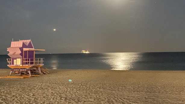 A lifeguard tower at Miami Beach with a calm sea and a bright moon in the sky. - 3Bd. & 2Bth. Private Island Security Gated Villa Miami Beach (North Bay Village)
