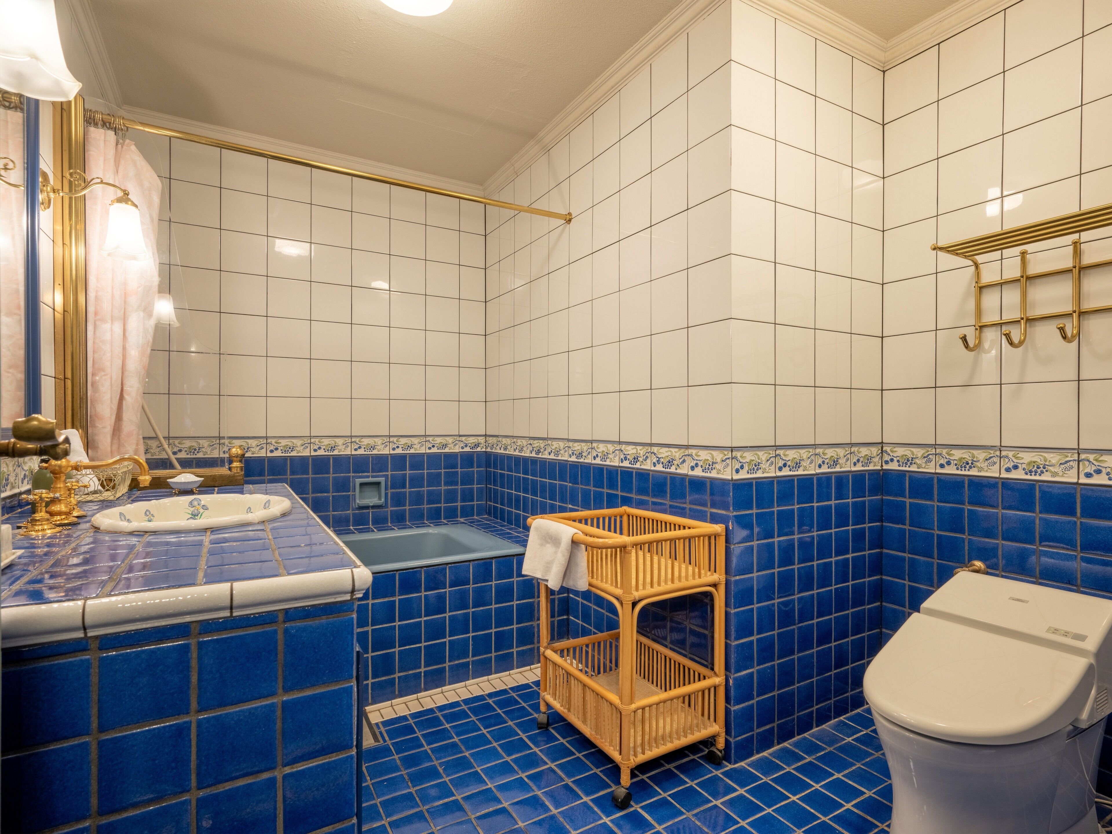 A bathroom with a bathtub, a toilet, and a sink.