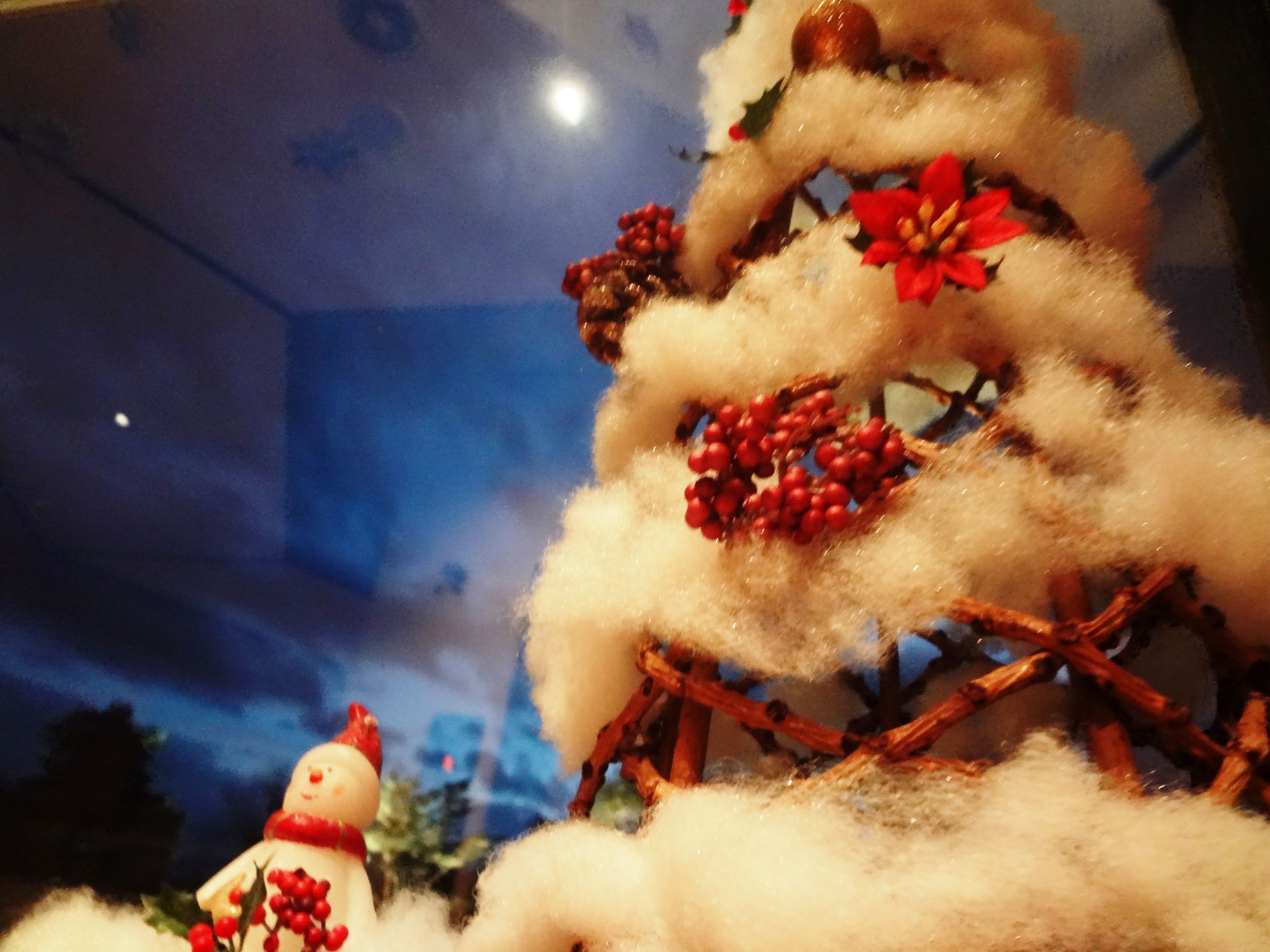 A Christmas tree with decorations and a snowman figure.