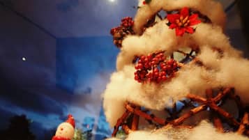 A Christmas tree with decorations and a snowman figure.