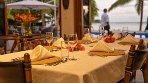 A dining table set for a meal with a view of the ocean. - All inclusive Beachfront Villa in Fiji! (Sigatoka)