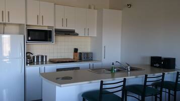 Two Bedroom King Apartment | Private kitchen | Microwave, coffee/tea maker, electric kettle, cookware/dishes/utensils