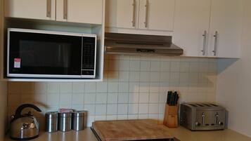 Two Bedroom King Apartment | Shared kitchen | Microwave, coffee/tea maker, electric kettle, cookware/dishes/utensils