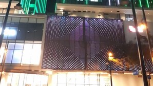 A modern building with vertical green lighting and a large digital display at the entrance. - Uptown BGC near St. Luke's (Taguig)
