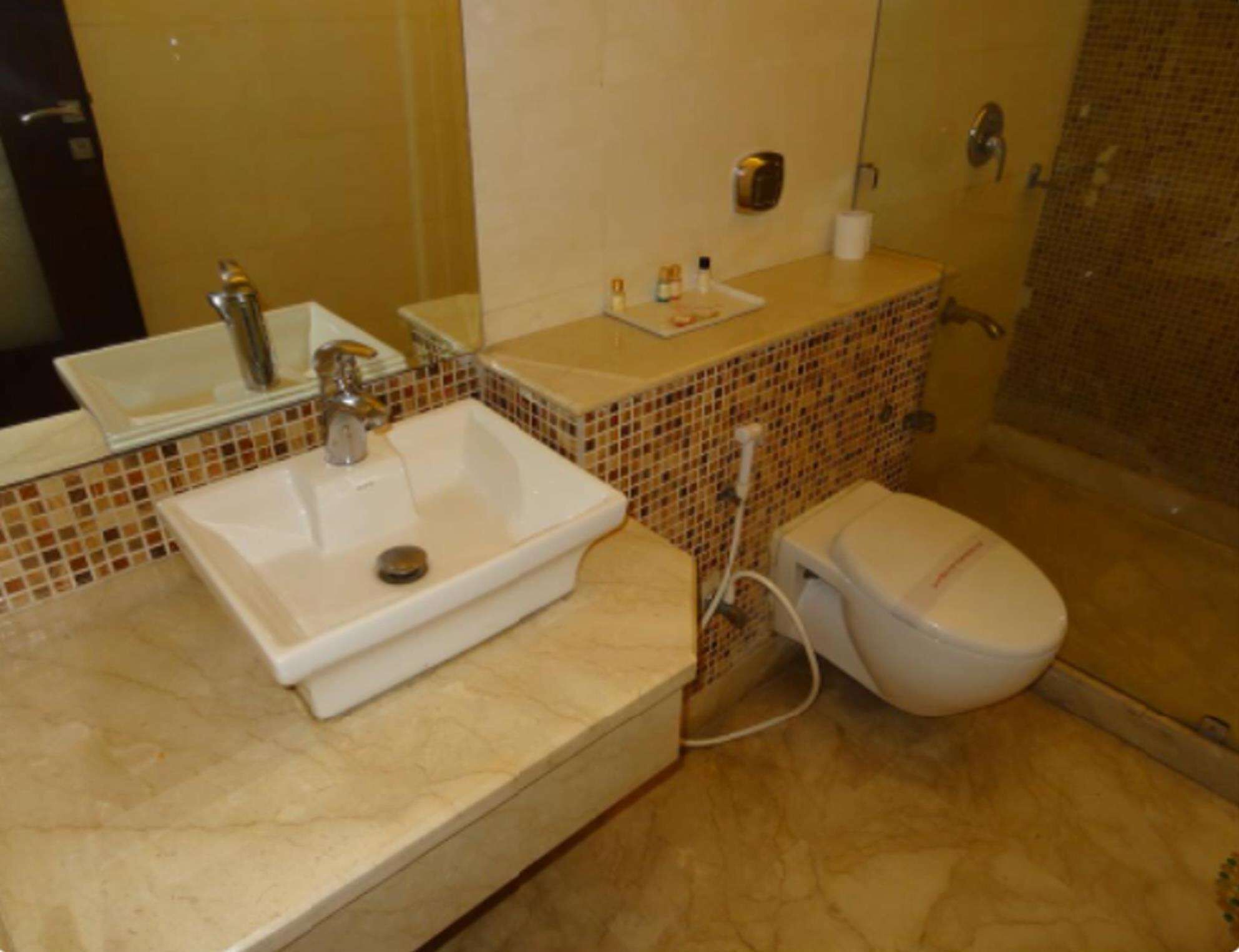 A bathroom with a sink, toilet, and shower.