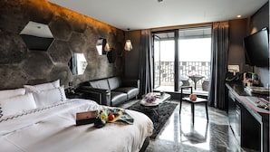 A modern hotel room with a large bed, a sofa, a dining area, and a TV. - Jeonju Mari Hotel Terminal Store (Jeonju)