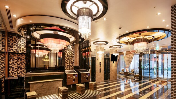 A luxurious lobby with a grand chandelier, a reception desk, and a check-in counter. - APA Hotel Osaka Umeda (Osaka)