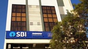 A building with a blue sign reading "SBI" and "STATE BANK OF INDIA". - Eco Inn Hotel (Jamnagar)
