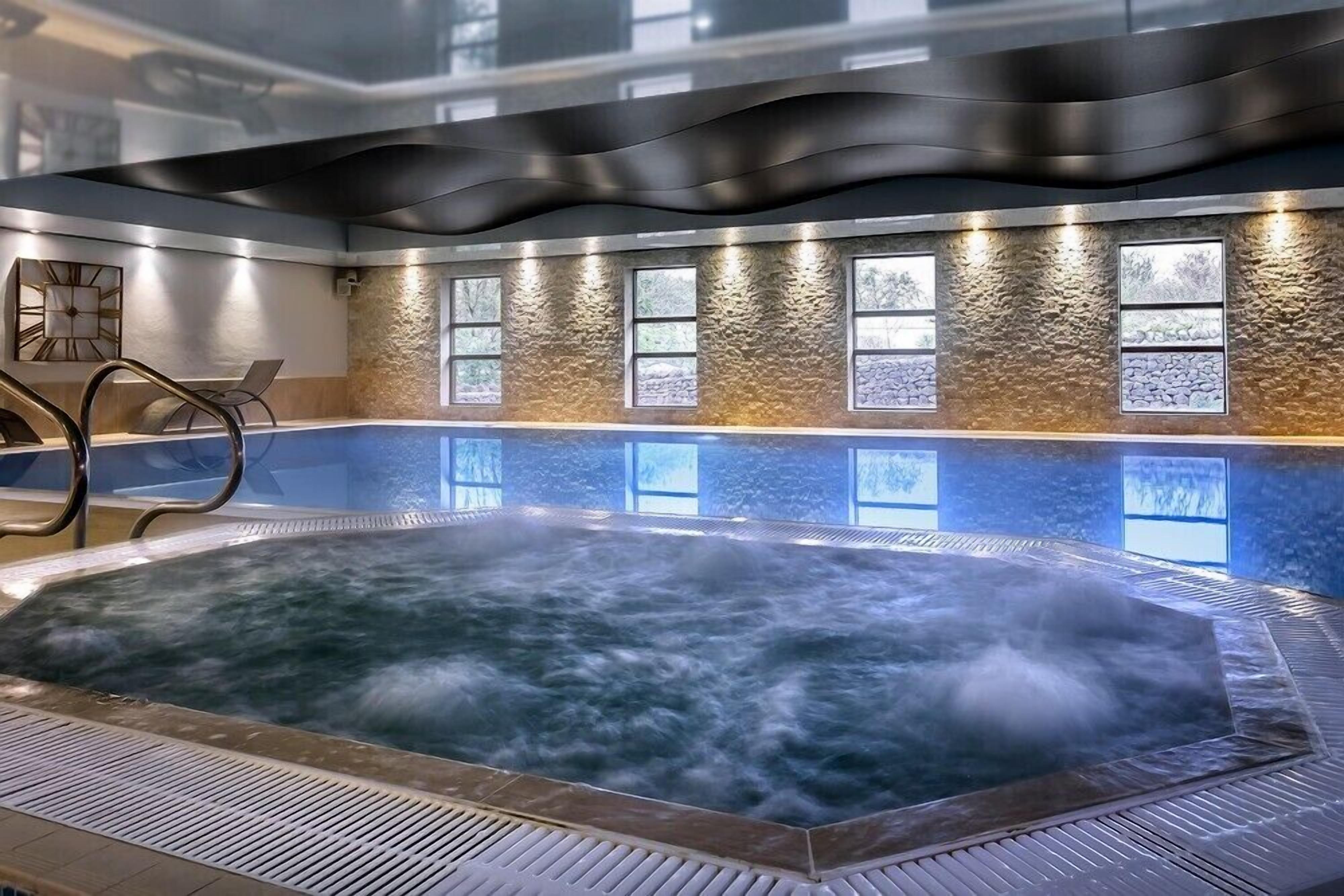 A hot tub with a textured wall and windows.